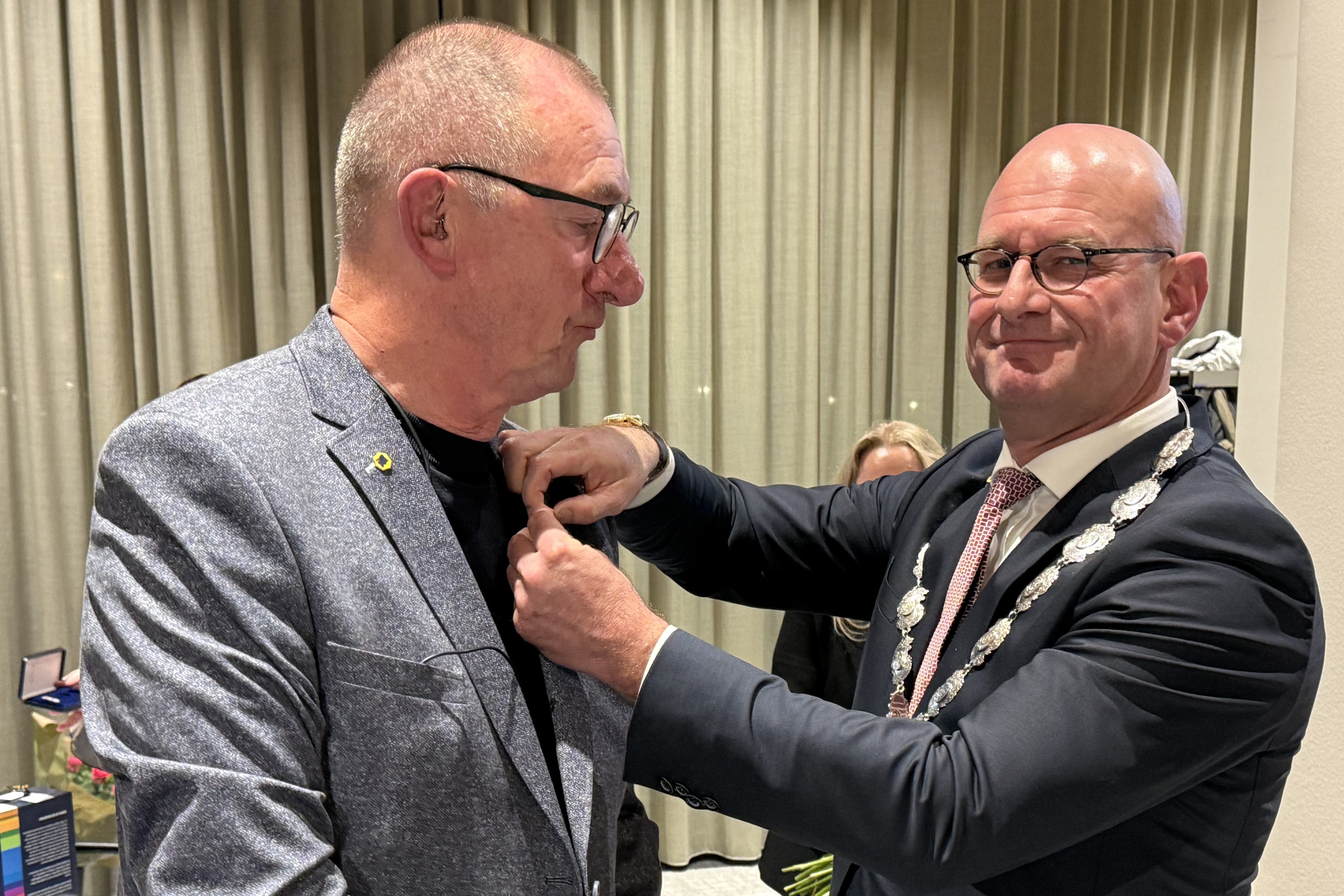 Burgemeester Nieuwenburg speldt Aart Ruppert de onderscheiding op